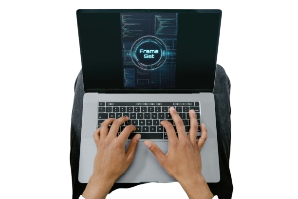 Top-down view of a person typing on a silver laptop with a black screen displaying a digital interface, set against a plain white background.